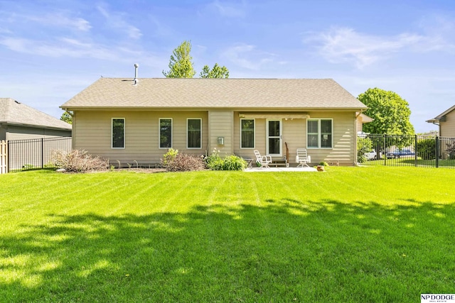 rear view of house with a yard, fence private yard, and a patio area