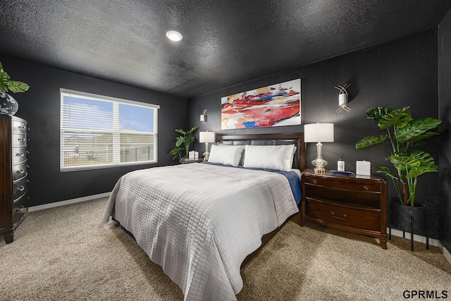 carpeted bedroom featuring baseboards and a textured ceiling