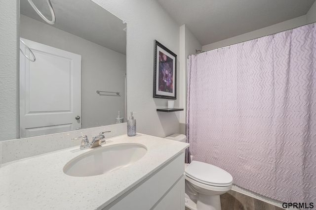 bathroom with vanity, toilet, and a shower with shower curtain