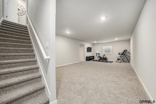 exercise area featuring baseboards, recessed lighting, and carpet floors