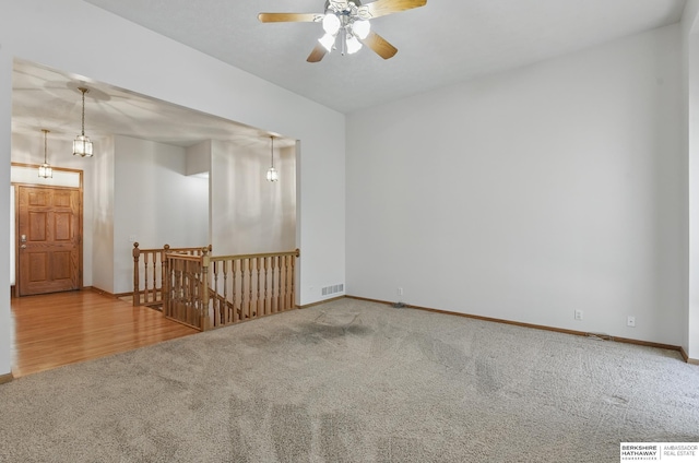 unfurnished room featuring carpet flooring, ceiling fan, and baseboards