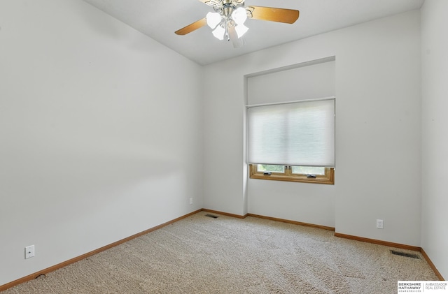empty room featuring a ceiling fan, carpet, and baseboards