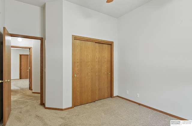 unfurnished bedroom featuring carpet, baseboards, and ceiling fan