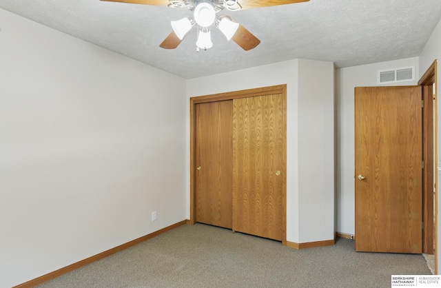 unfurnished bedroom featuring carpet, baseboards, and a closet