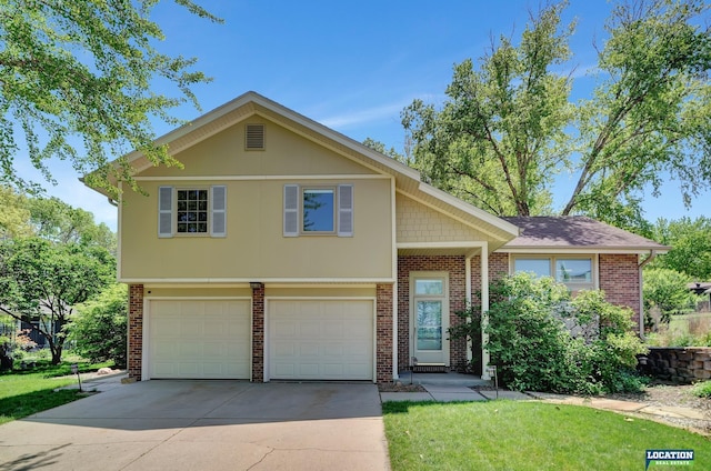tri-level home featuring concrete driveway, a front lawn, brick siding, and a garage
