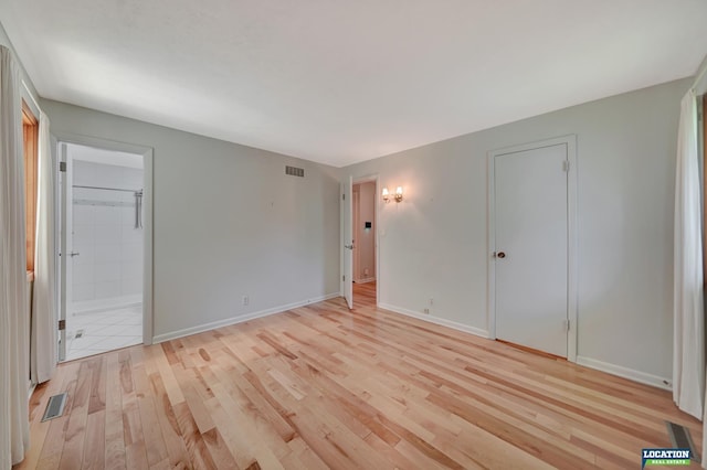 unfurnished bedroom featuring visible vents, light wood-style flooring, and baseboards