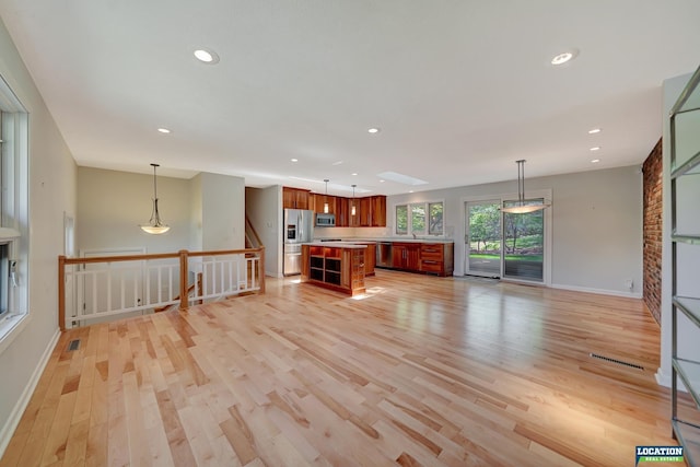 unfurnished living room featuring light wood-type flooring, recessed lighting, baseboards, and visible vents