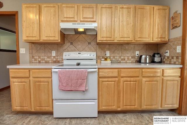 kitchen with light countertops, tasteful backsplash, electric stove, and under cabinet range hood