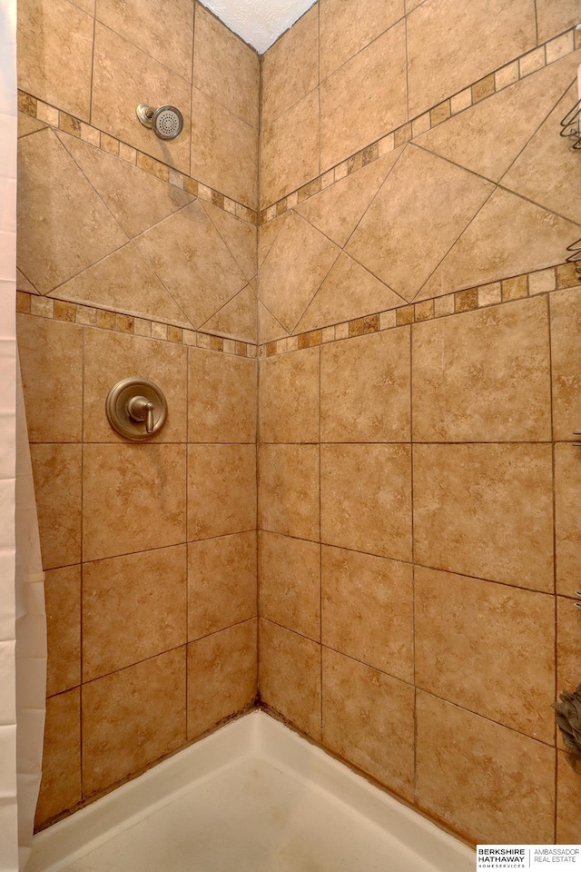 bathroom with tiled shower