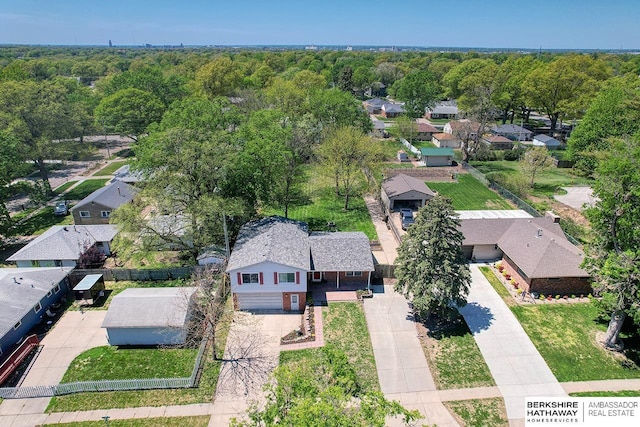 bird's eye view with a wooded view and a residential view