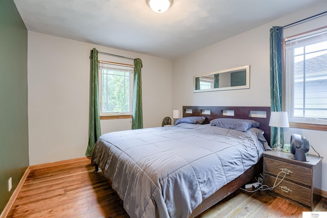 7545 Sherman Dr, Omaha, NE 68134 - bedroom with wood finished floors, multiple windows, and baseboards
