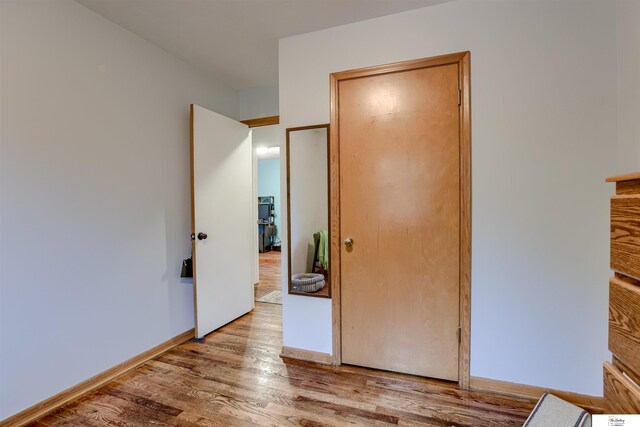7545 Sherman Dr, Omaha, NE 68134 - unfurnished bedroom with wood finished floors and baseboards