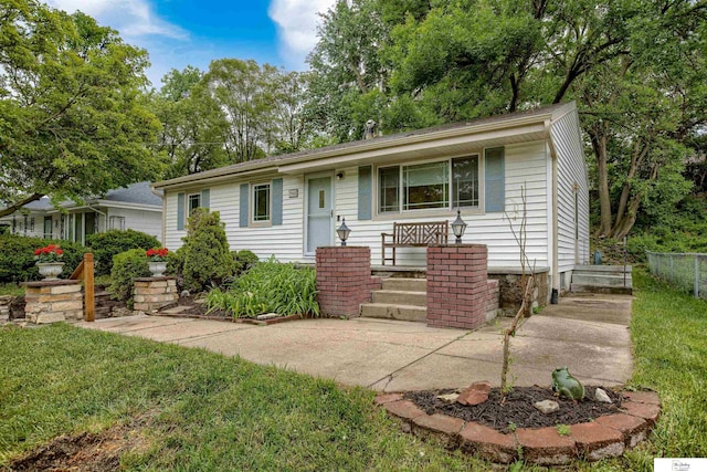 7545 Sherman Dr, Omaha, NE 68134 - ranch-style home with a front lawn and view of scattered trees
