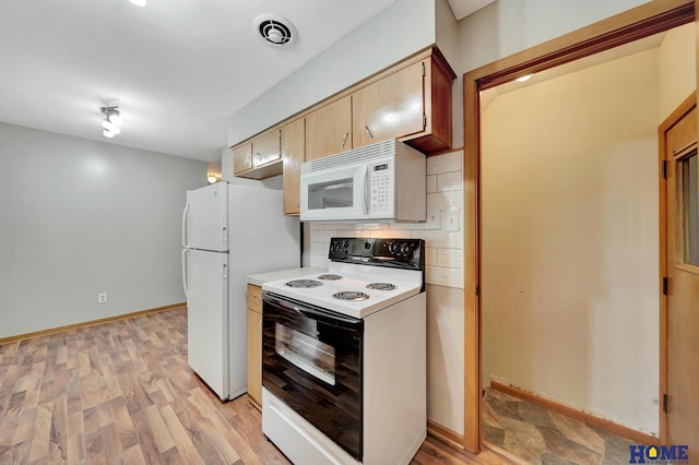kitchen featuring light wood-style flooring, white appliances, light countertops, and backsplash