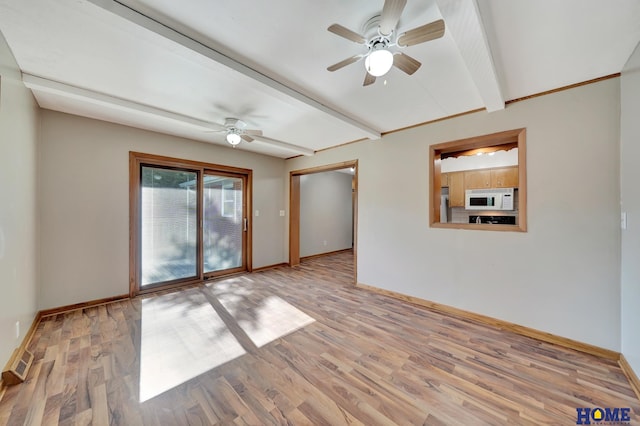 empty room featuring baseboards, light wood-type flooring, beam ceiling, and a ceiling fan