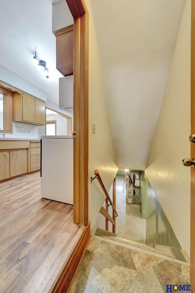 stairs featuring wood finished floors