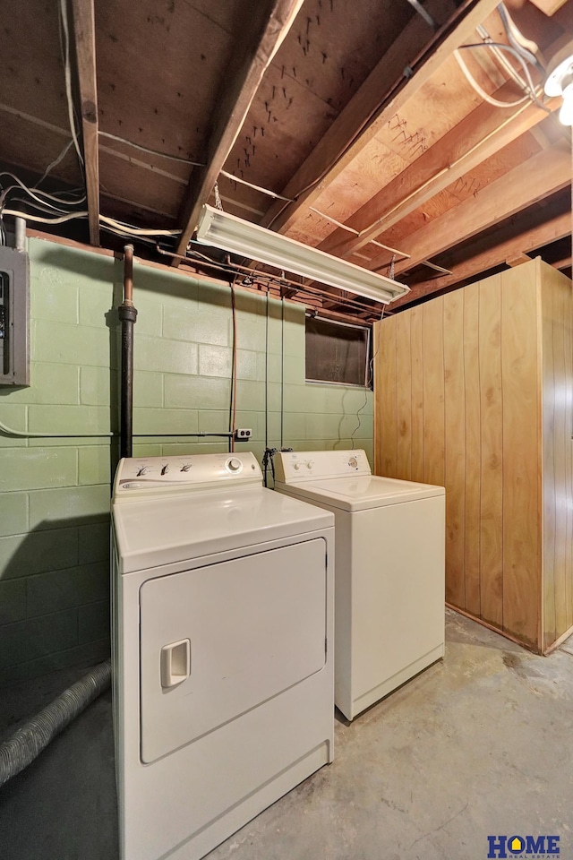 clothes washing area featuring electric panel, laundry area, and independent washer and dryer
