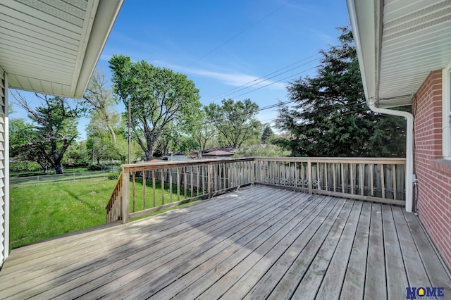 wooden terrace featuring a lawn