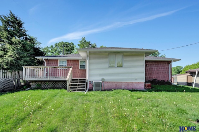 rear view of house featuring central AC, a deck, a yard, and fence