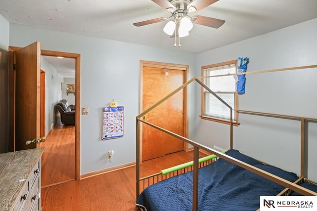 bedroom with light wood finished floors and baseboards