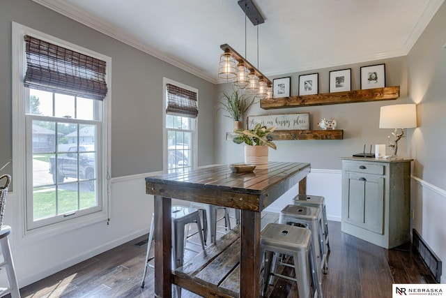 dining room featuring ornamental molding and dark wood-type flooring