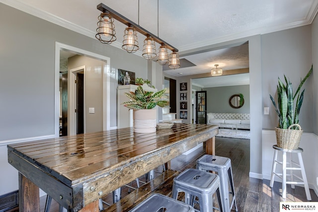 kitchen featuring dark wood-style flooring, ornamental molding, and baseboards