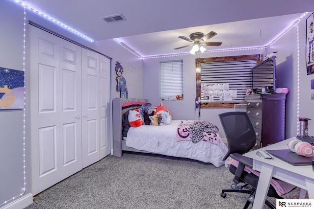 bedroom with carpet floors, an office area, ceiling fan, and a closet
