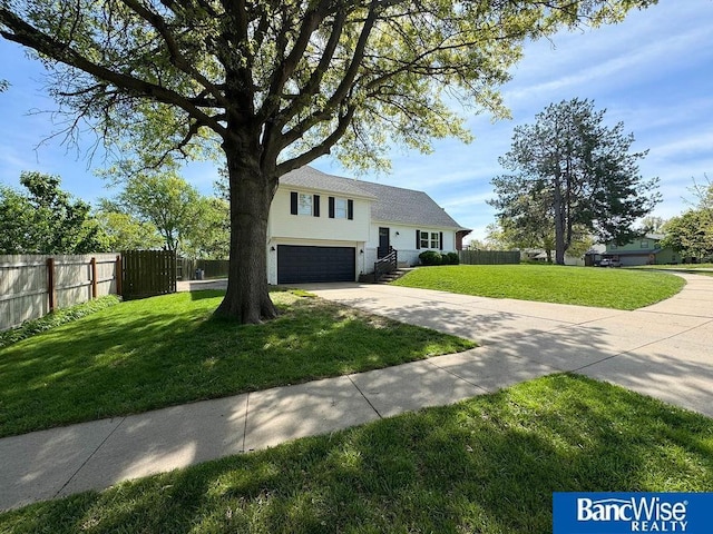 split level home featuring driveway and a garage