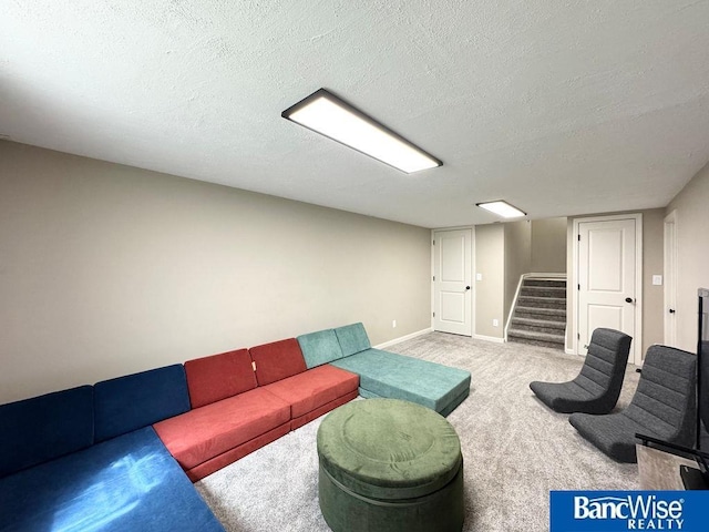 carpeted living room featuring stairway, a textured ceiling, and baseboards