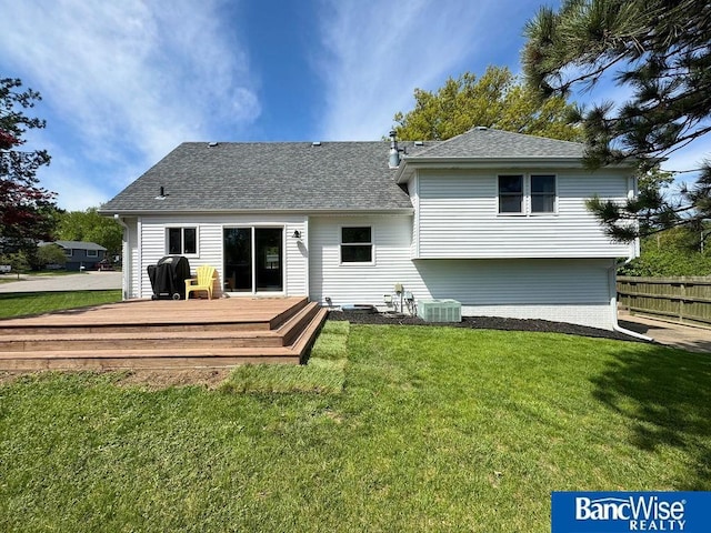 rear view of property featuring a wooden deck, roof with shingles, and central AC