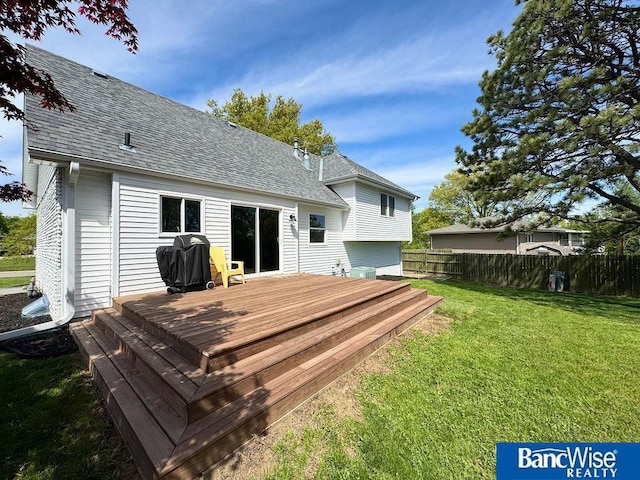 back of house with a wooden deck and roof with shingles