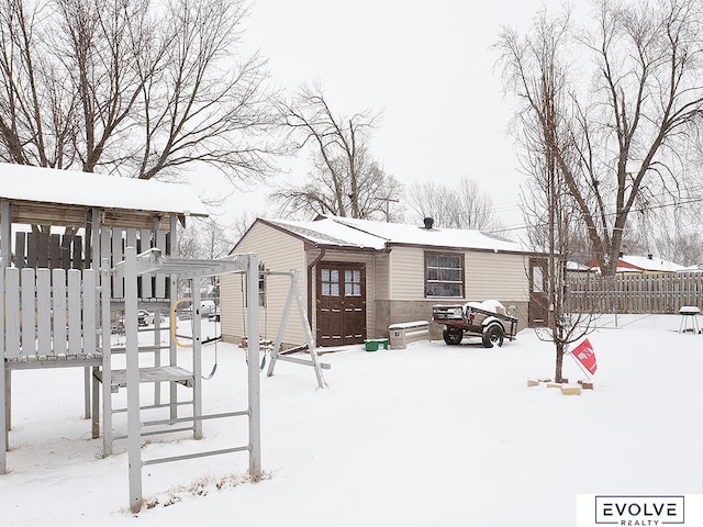 yard layered in snow featuring fence