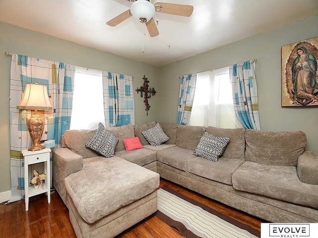 living room featuring hardwood / wood-style floors and ceiling fan