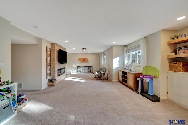 playroom with light carpet, a fireplace, baseboards, and recessed lighting