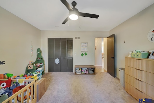 recreation room with ceiling fan and light colored carpet
