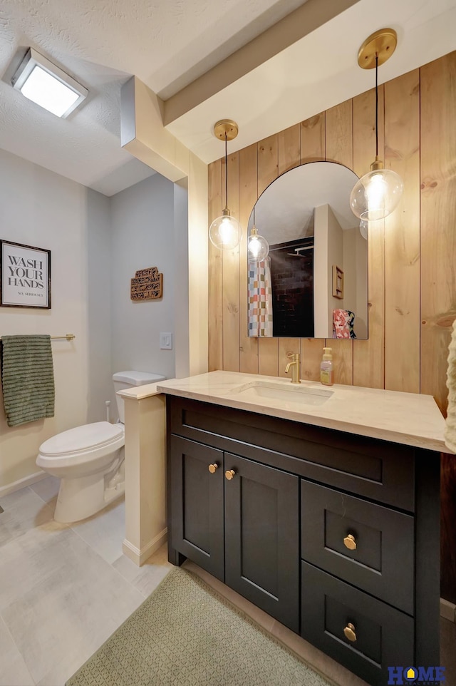 full bath with toilet, vanity, baseboards, and tile patterned floors