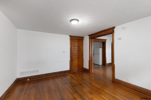 409 N 25th St, Lincoln, NE 68503 - spare room featuring wood finished floors, baseboards, and a textured ceiling