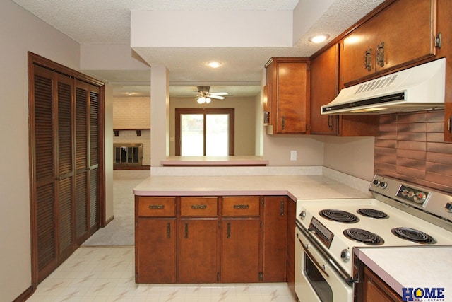 kitchen with range with electric cooktop, under cabinet range hood, light countertops, a ceiling fan, and a textured ceiling