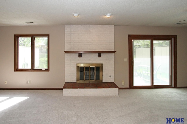 unfurnished living room with carpet, baseboards, and a fireplace