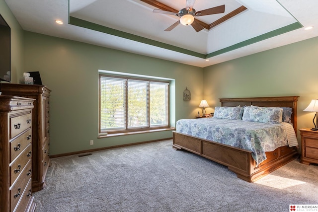 bedroom with a raised ceiling, carpet, baseboards, recessed lighting, and a ceiling fan