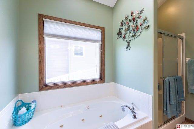 full bathroom with plenty of natural light, a stall shower, and a whirlpool tub