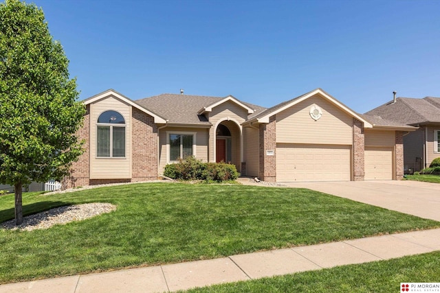 single story home featuring brick siding, a garage, concrete driveway, and a front lawn