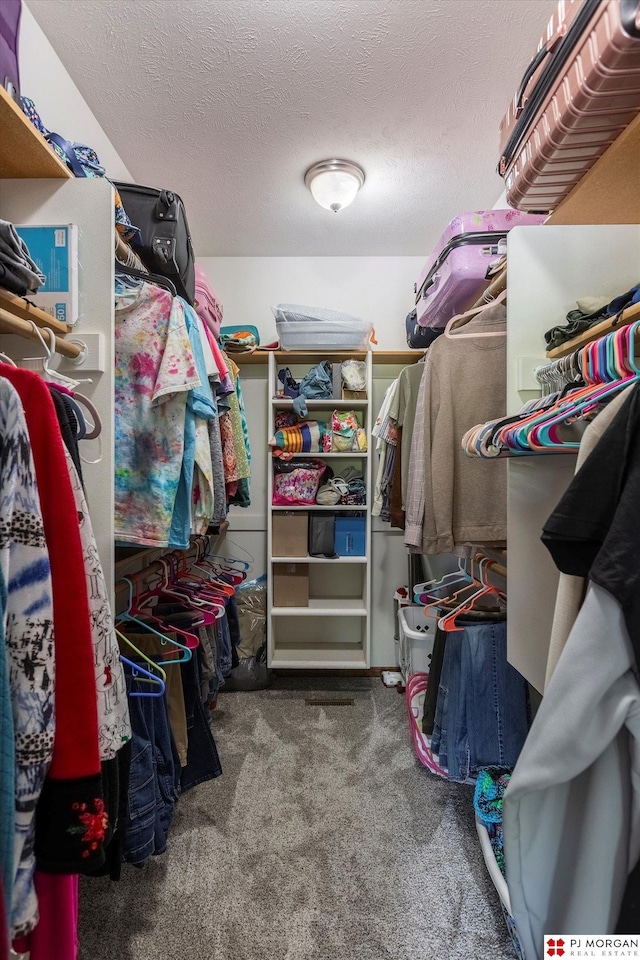 walk in closet with carpet floors