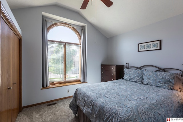 carpeted bedroom featuring vaulted ceiling, multiple windows, baseboards, and ceiling fan