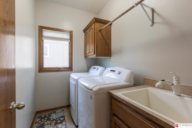 laundry room with washing machine and dryer, cabinet space, and baseboards