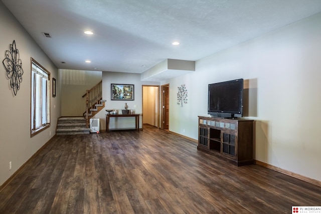 unfurnished living room with wood finished floors, stairway, recessed lighting, and baseboards