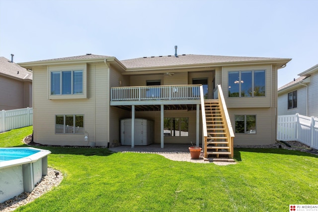 rear view of property with stairs, a wooden deck, and a patio