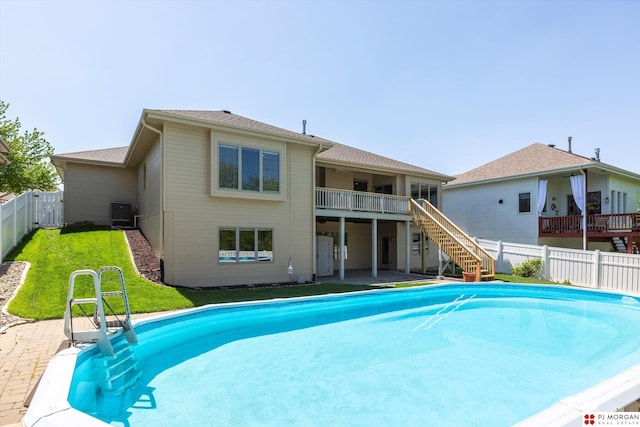 view of swimming pool with stairs, central AC unit, and a patio