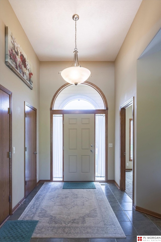tiled entrance foyer with baseboards