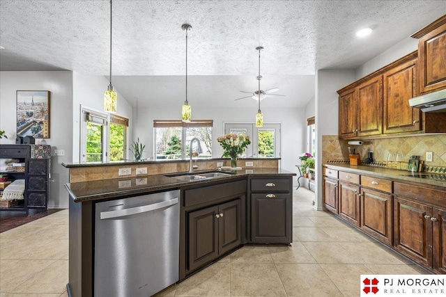 kitchen featuring a textured ceiling, stainless steel dishwasher, ceiling fan, a sink, and tasteful backsplash